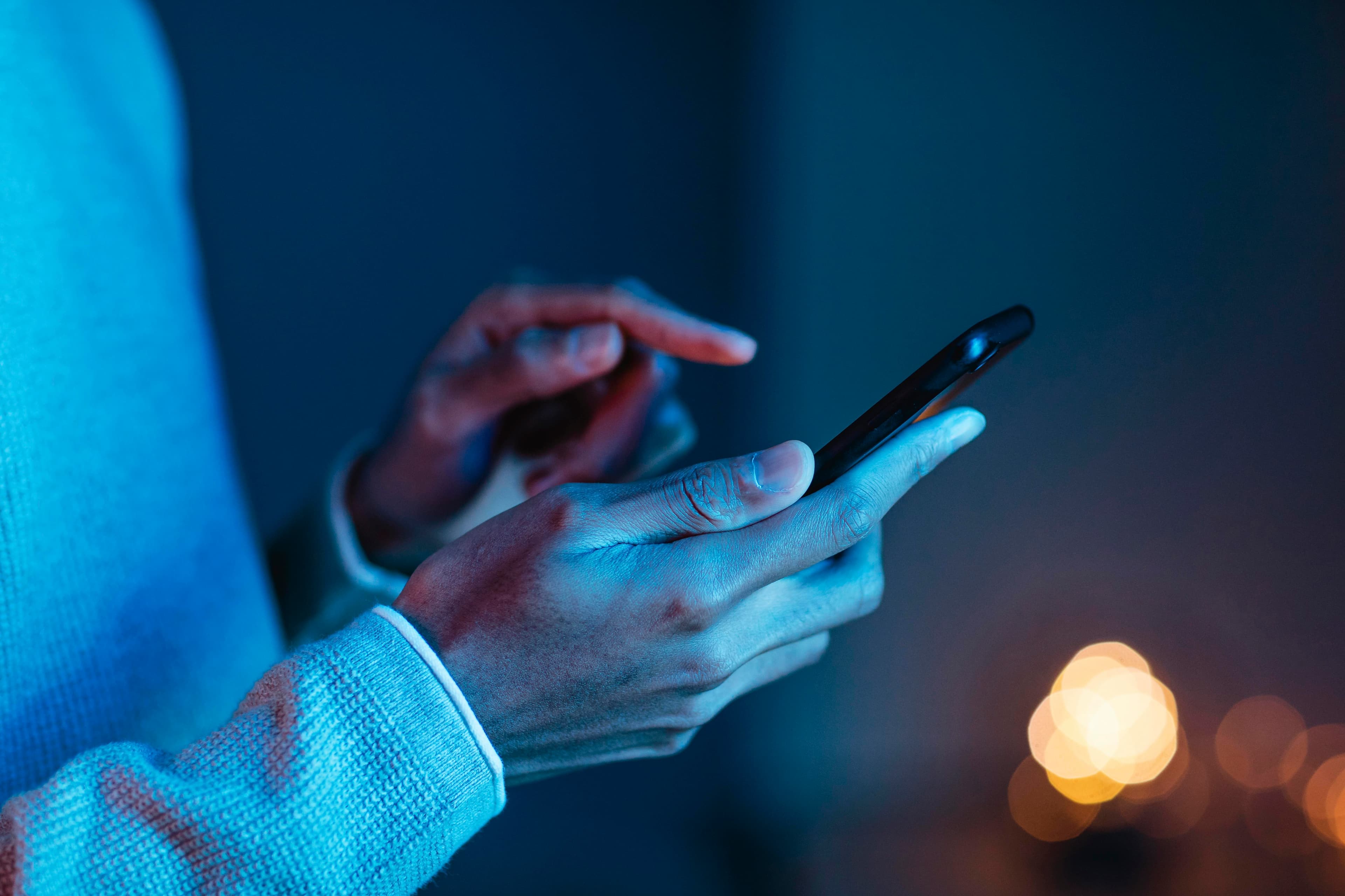 Person interacting with smartphone, illustrating real-time rich messaging, customer engagement, and secure communication enabled by RCS Business Messaging.